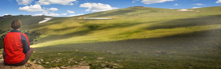 Sitting looking over grass hill - All About Life Challenges Banner